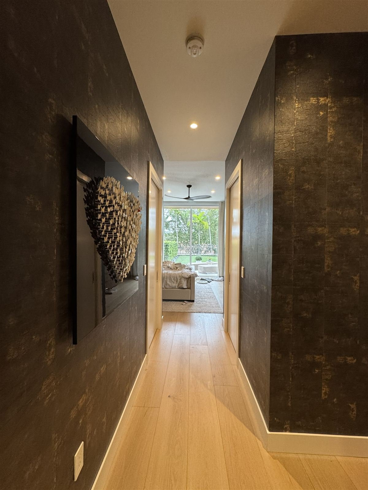 Coral Gables master suite hallway — black metallic wallcovering